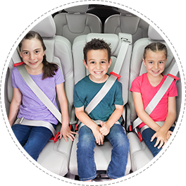 three children sitting comfortably on their mifold boosters in a row